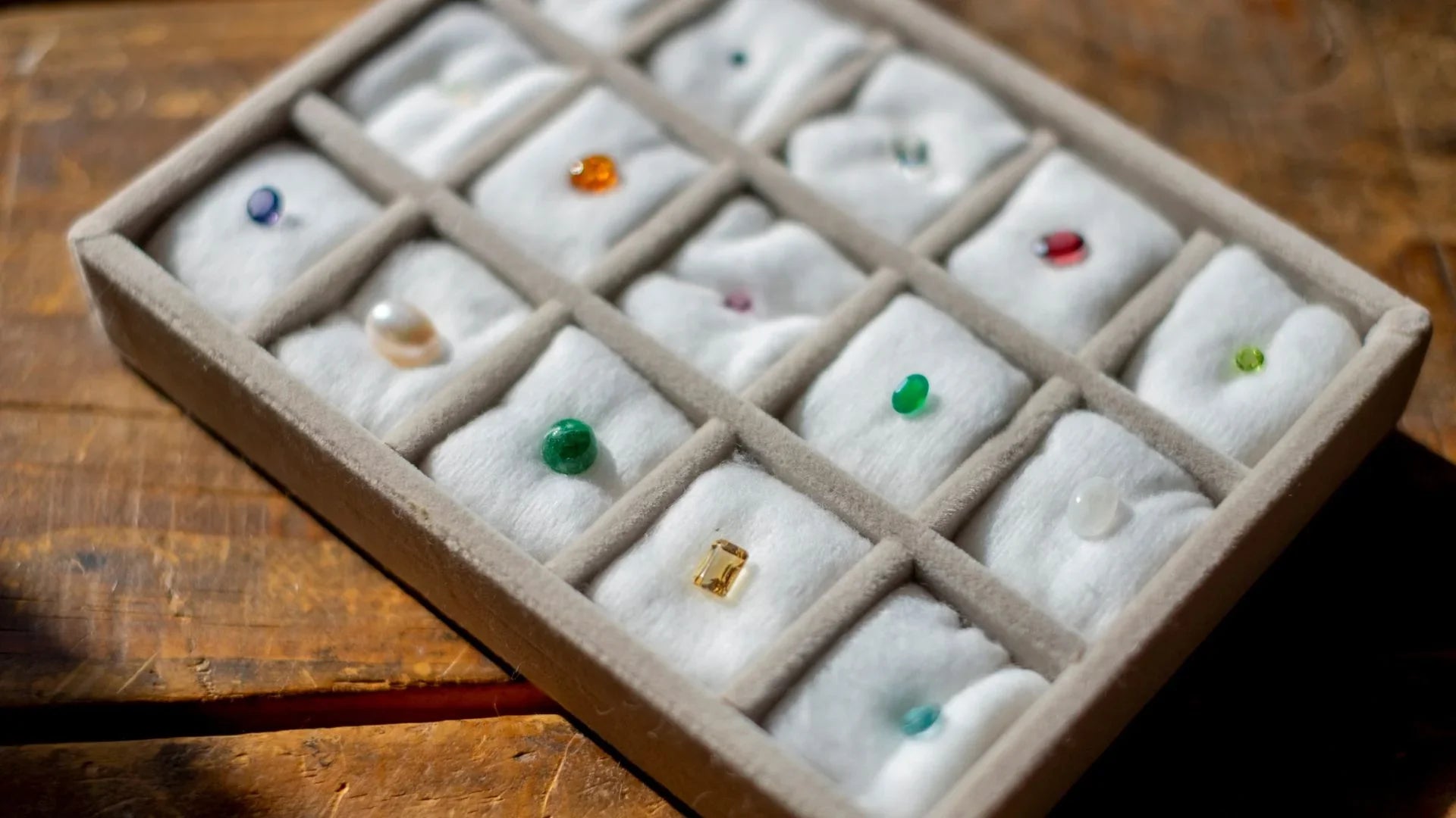 Assorted loose gemstones in a display box on cotton, gemstones wholesale collection